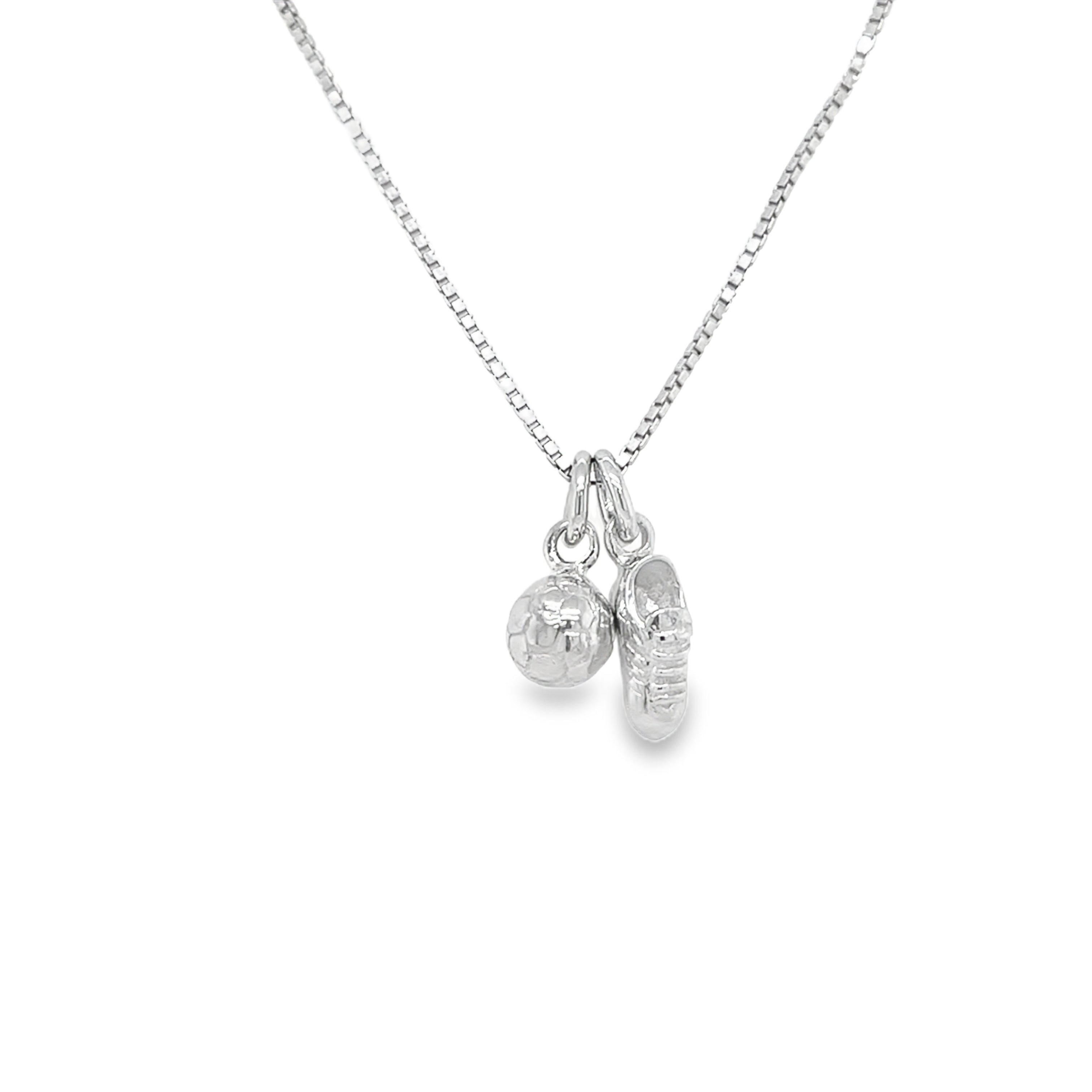 Children's silver necklace with football boot and a football.